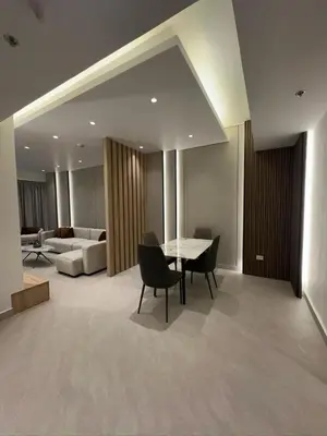 a living room with a table and chairs and a couch at Damac Tower Amman - Luxury Studio - استوديوهات فاخرة - داماك عمان العبدلي in Amman