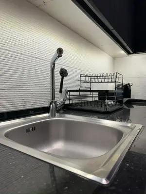 a kitchen sink with a faucet on a counter at Damac Tower Amman - Luxury Studio - استوديوهات فاخرة - داماك عمان العبدلي in Amman