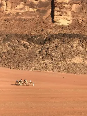 a group of people riding horses in the desert at Wadirum Zeid Classic camp in Wadi Rum