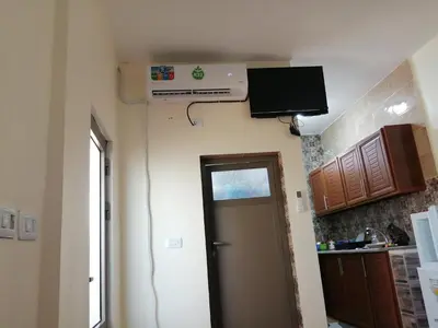 a room with a door and a television on the wall at family studio in Wadi Musa