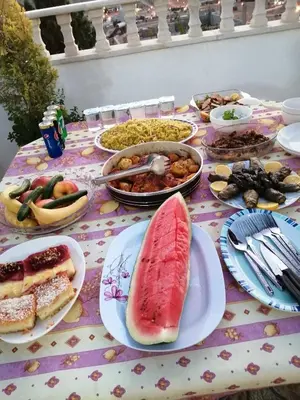 a table topped with plates of food on a table at family studio in Wadi Musa