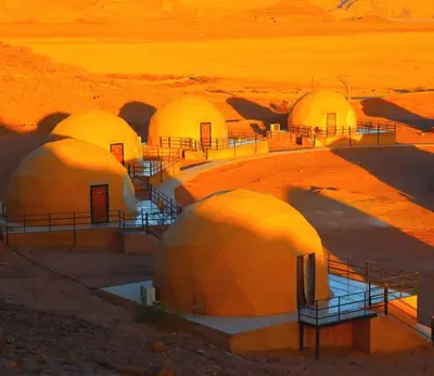 a group of domes in the middle of a desert at Jabal Rum Camp in Wadi Rum