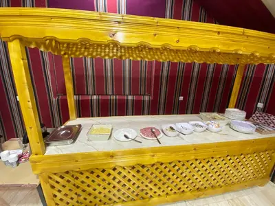 a yellow table with plates on top of it at Allen Luxury Wadi Rum in Wadi Rum