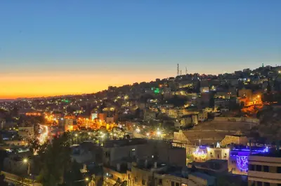 a view of a city at night with lights at The Castle Star in Amman