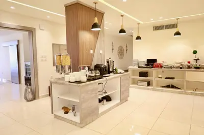 a large kitchen with a counter in the middle at Luciana Hotel by FHM in Aqaba