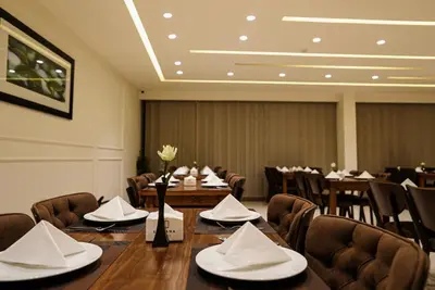 a conference room with a table and chairs in it at Luciana Hotel by FHM in Aqaba