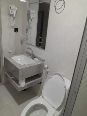 a bathroom with a toilet and a sink and a mirror at Aun Wadi Rum Camp in Wadi Rum