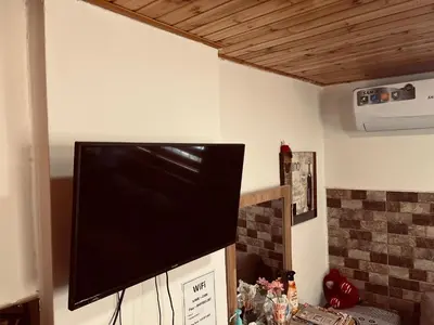 a flat screen tv hanging on a wall at IBN Khaldoon in Madaba