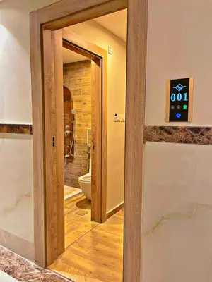 a bathroom with a door leading to a toilet at ALENA HOTEL in Aqaba