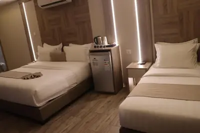 a hotel room with two beds in a room at ALENA HOTEL in Aqaba