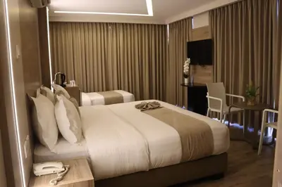a hotel room with a large bed and a table at ALENA HOTEL in Aqaba