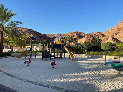 a group of children playing on a playground at Al Raha Village - Aqaba in Aqaba