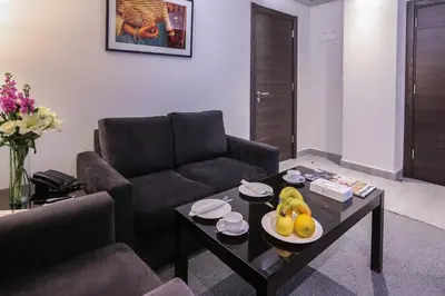 a living room with a couch and a table with fruit on it at Khuttar Apartment in Amman