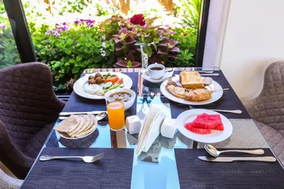 a table with plates of food on top at Khuttar Apartment in Amman