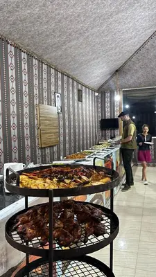 a buffet with several trays of pizzas on display at Night Magic Camp in Wadi Rum
