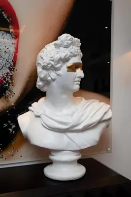 a white statue of a bust sitting on a shelf at Hotel Philosophy in Amman