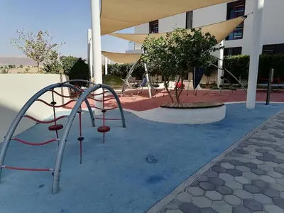 a playground in front of a building at Blue Diamond Ayla - Restricted to Family stays in Aqaba