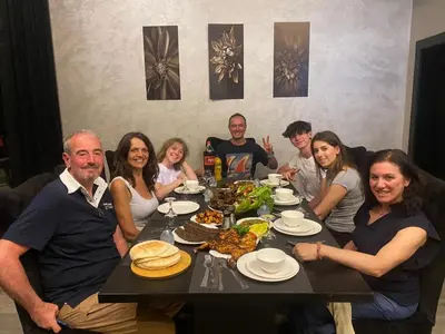 a group of people sitting around a table with food at laperla chalet villa di lusso deadsea in Sowayma