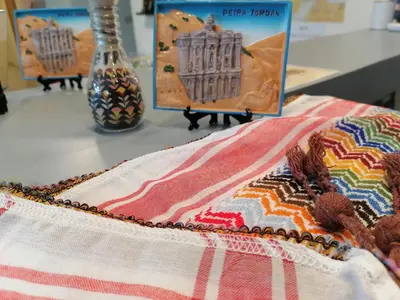 a table topped with a colorful blanket on a table at Rose city inn in Wadi Musa
