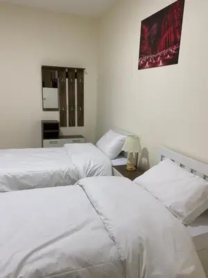 two beds sitting next to each other in a bedroom at Rose city inn in Wadi Musa