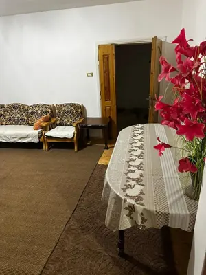 a living room with a table and a couch at Jordanian Baity Apartment in Wadi Musa