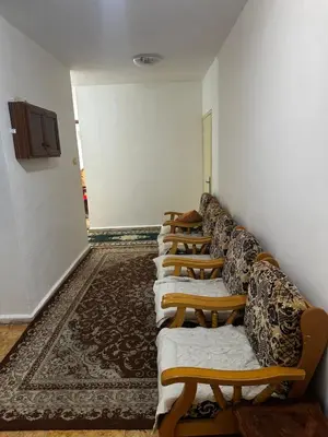 a row of chairs lined up against a wall at Jordanian Baity Apartment in Wadi Musa