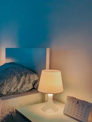 a bedroom with a bed and a table with a lamp at Full panorama Jerash (PLUS) in Jerash
