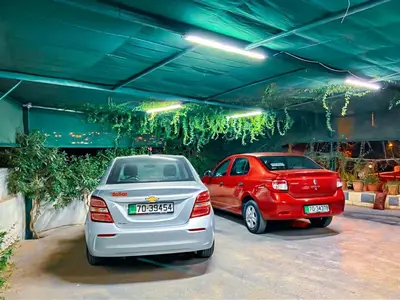 two cars are parked in a parking garage at Full panorama Jerash (PLUS) in Jerash