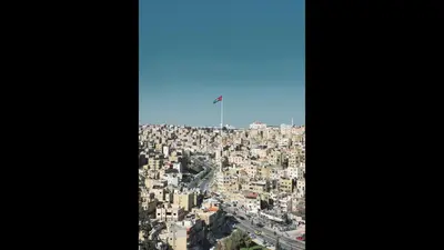 an aerial view of a city with a flag on top at The Royal Luxury Superior Queen cot in Amman