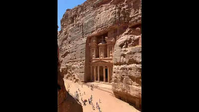a group of people standing in front of a building on a cliff at The Royal Luxury Superior Queen cot in Amman