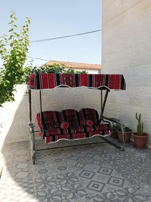 a bench sitting on a patio with sidx sidx sidx at Jerash air apartment in Jerash