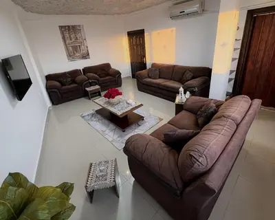 a living room with couches and a coffee table at Petra Cloud 1977 in Wadi Musa