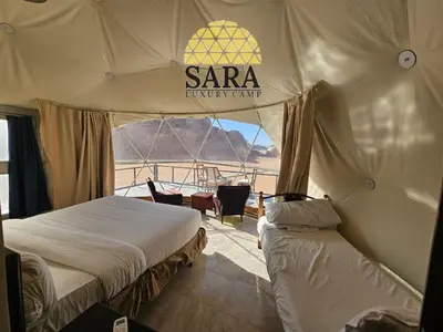 a bedroom with two beds in a tent at SARA lUXURY CAMP in Wadi Rum