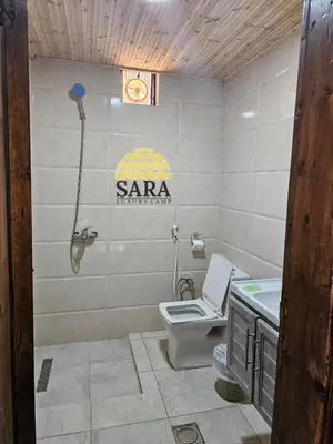 a bathroom with a toilet and a sink at SARA lUXURY CAMP in Wadi Rum