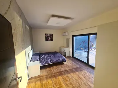 a bedroom with a bed and a sliding glass door at Zoom Chalets in Amman