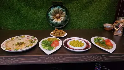 a table with four plates of food on it at petra Casablanca lodge in Wadi Musa