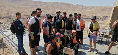 a group of people posing for a picture at the grand canyon at Alhidan Hostel & adventure in Madaba