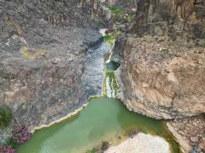 an aerial view of a river between two rocks at Alhidan Hostel & adventure in Madaba