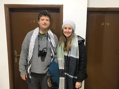a man and a woman standing in front of a door at Elite Furnished Apartment in Wadi Musa