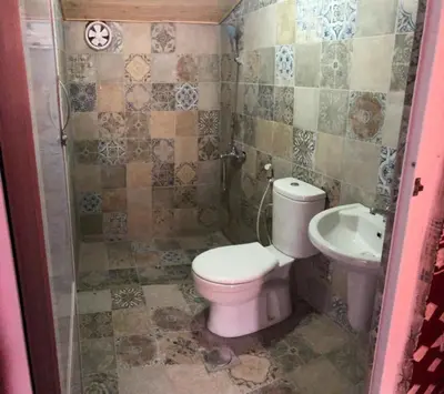 a small bathroom with a toilet and a sink at Obeid's Bedouin Life Camp in Wadi Rum