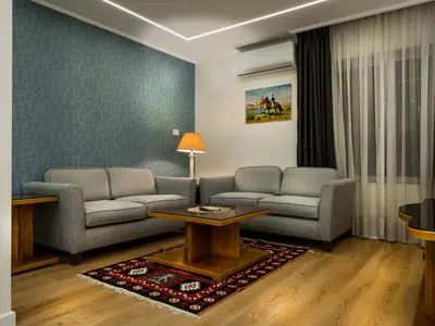 a living room with two couches and a table at Prestige Hotel Suites - برستيج للشقق الفندقية in Amman