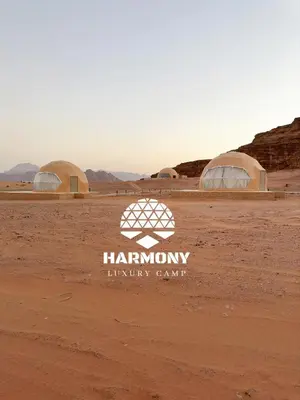 a group of three domes in the desert at Harmony Luxury Camp in Wadi Rum