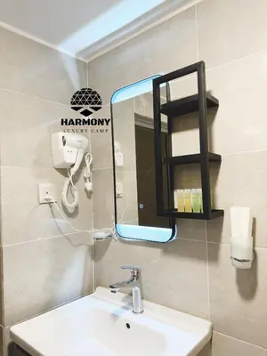 a bathroom with a sink and a mirror at Harmony Luxury Camp in Wadi Rum