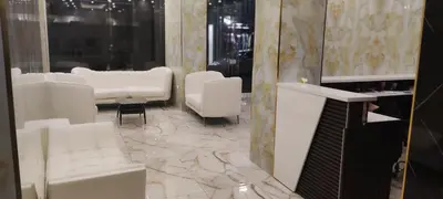 a living room with white furniture and marble floors at Golden Hotel in Amman