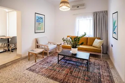 a living room with a couch and a table at Julia's Hotel Suites in Amman
