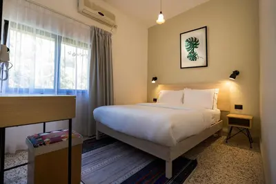 a hotel room with a bed and a window at Julia's Hotel Suites in Amman