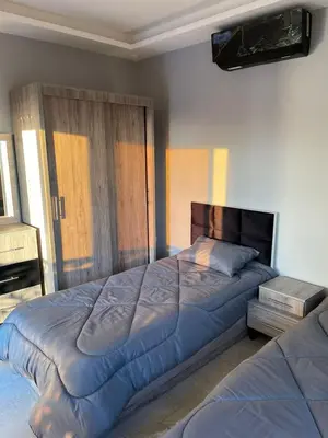 a bedroom with two beds and a large bed sidx sidx sidx at Villa Jana Chalet in Ash Shāghūr