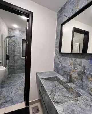 a bathroom with a tub and a sink and a mirror at Follow Sea Villa in Sowayma