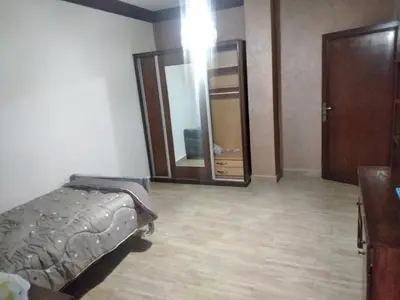 a bedroom with a bed and a large mirror at City Center Furnished Apartment in Madaba