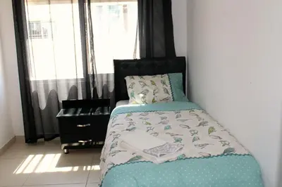 a bedroom with a bed and a window at The Place Apartments in Amman
